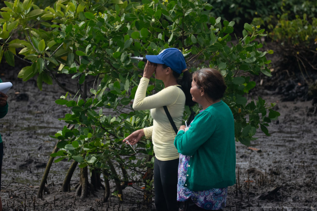 a community member using a refractometer for the CBEMR training